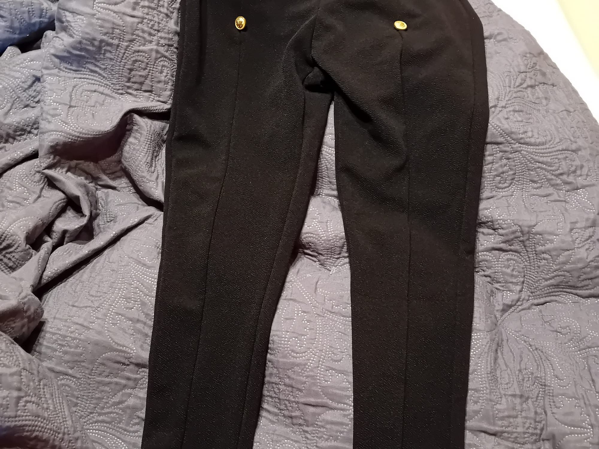 Black trousers with gold buttons